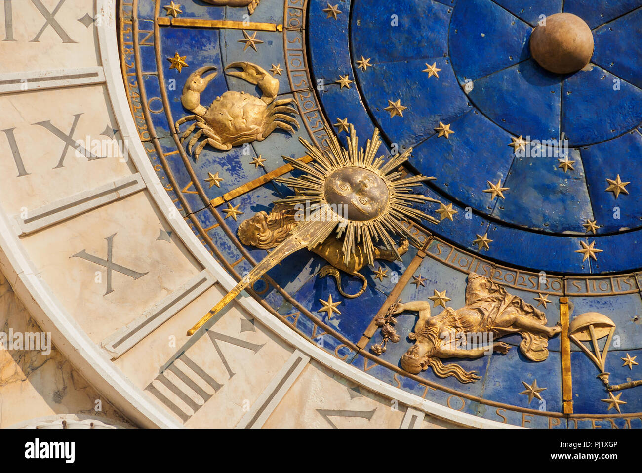 Ancient time and Astrology. Detail of Saint Mark Square renaissance Clock Tower in Venice with zodiac signs of summer: Leo, Cancer, Virgo, planets and Stock Photo