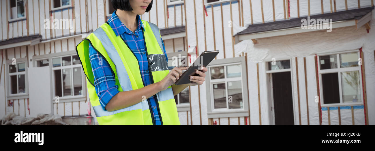 Composite image of female architect using digital tablet Stock Photo