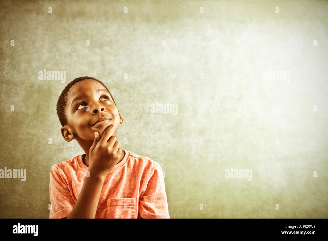 Thoughtful boy against greenboard Stock Photo