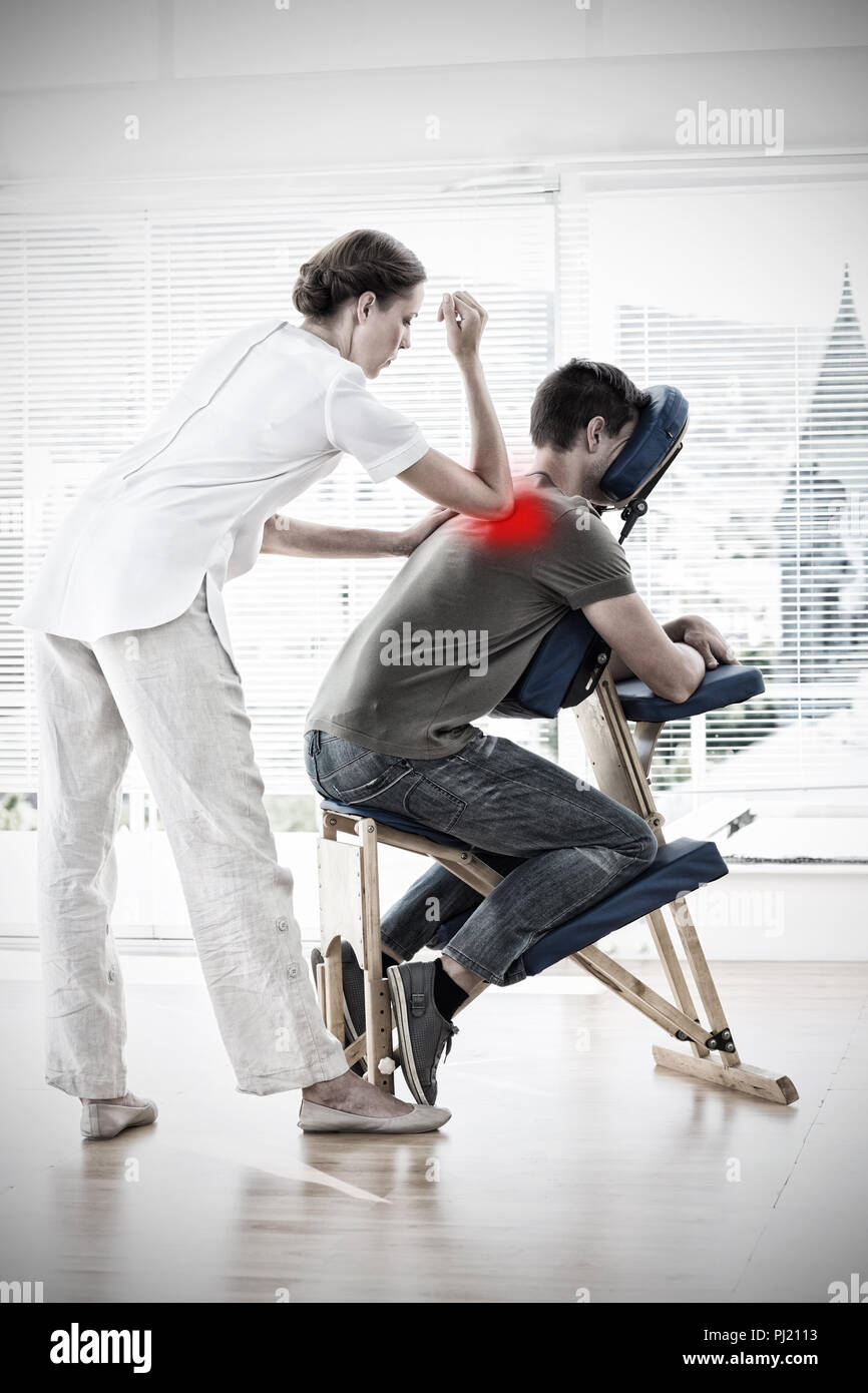 Massage therapist giving massage hires stock photography and images