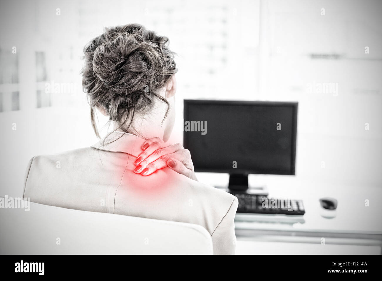 Composite image of rear view of businesswoman with neck pain in office Stock Photo