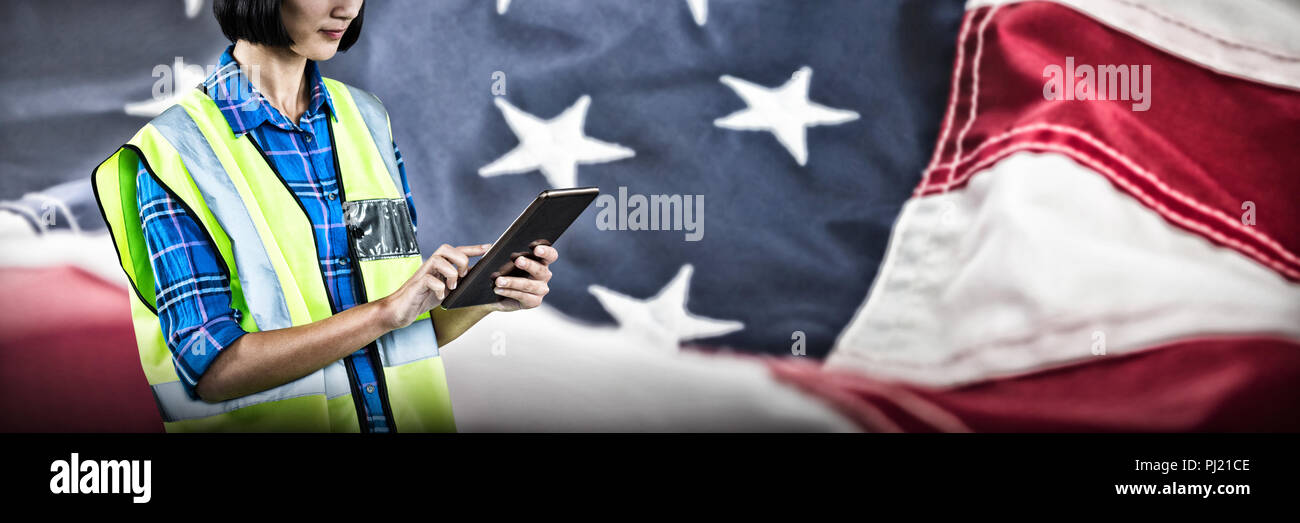 Composite image of female architect using digital tablet Stock Photo