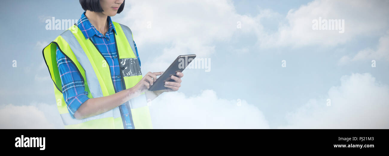 Composite image of female architect using digital tablet Stock Photo