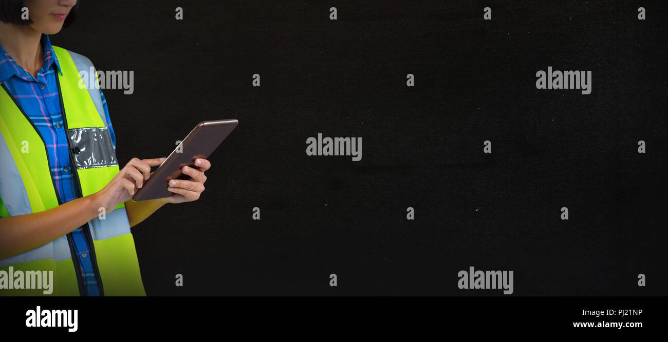 Composite image of female architect using digital tablet Stock Photo