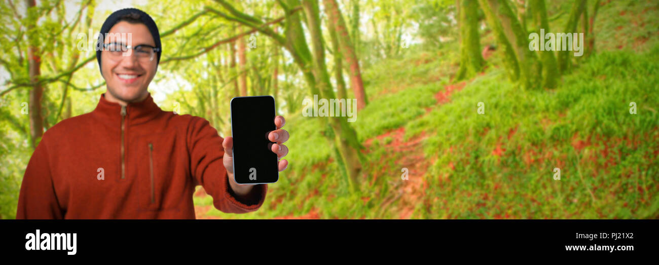 Composite image of man holding mobile phone Stock Photo