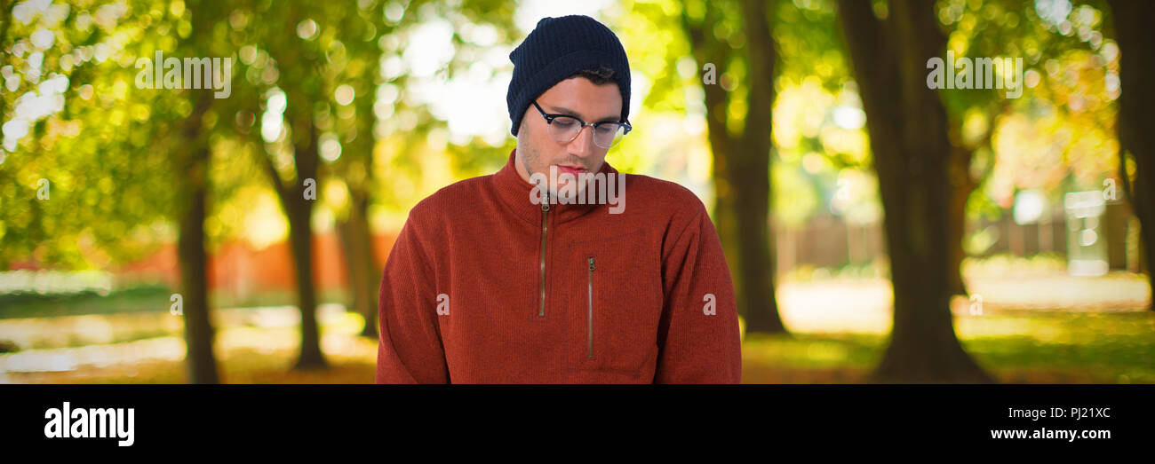 Composite image of man standing with hands in pocket Stock Photo