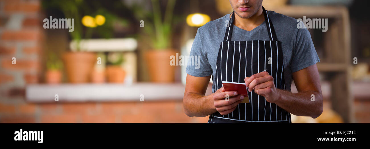 Composite image of male waiter taking order Stock Photo
