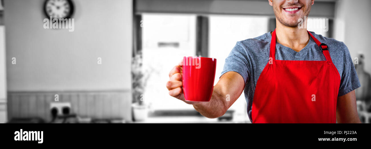 Composite image of male waiter holding coffee mug Stock Photo
