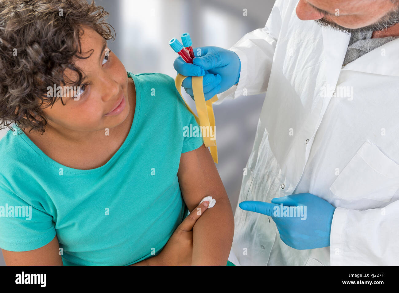 Blood Sample. Male Nurse taking blood sample from patient at the
