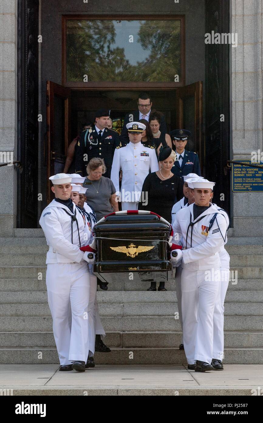 The flag draped casket of Sen. John McCain is lifted by Midshipmen on to a horse-drawn caisson for the procession to the United States Naval Academy Cemetery for his burial service September 2, 2018 in Annapolis, Maryland. John S. McCain, III graduated from the United States Naval Academy in 1958. He was a pilot in the United States Navy, a prisoner of war in Vietnam, a Congressmen and Senator and twice presidential candidate. He received numerous awards, including the Silver Star, Legion of Merit, Purple Heart, and Distinguished Flying Cross. Stock Photo