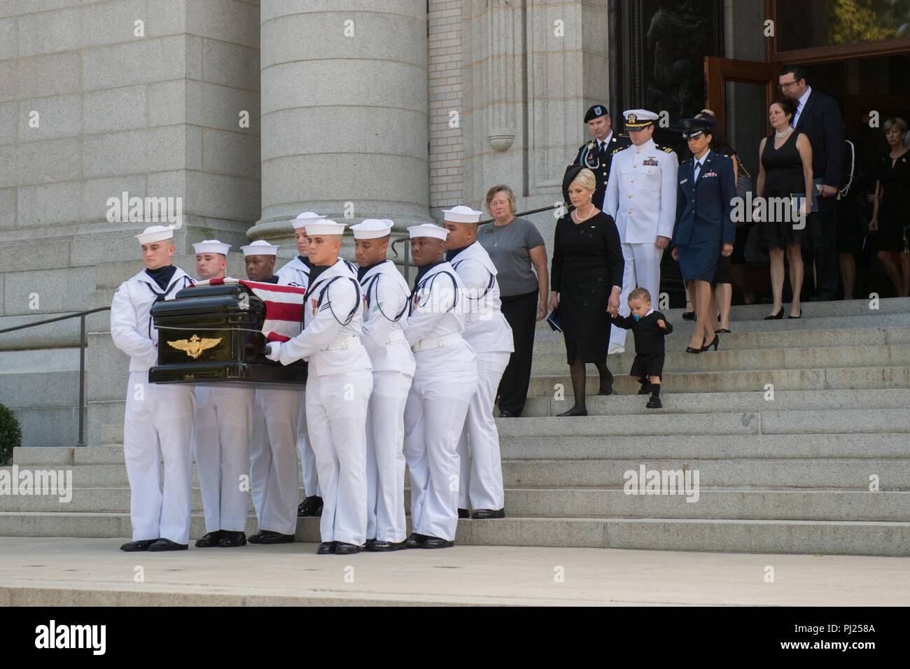 The flag draped casket of Sen. John McCain is carried by Midshipmen to a horse-drawn caisson for the procession to the United States Naval Academy Cemetery for his burial service September 2, 2018 in Annapolis, Maryland. John S. McCain, III graduated from the United States Naval Academy in 1958. He was a pilot in the United States Navy, a prisoner of war in Vietnam, a Congressmen and Senator and twice presidential candidate. He received numerous awards, including the Silver Star, Legion of Merit, Purple Heart, and Distinguished Flying Cross. Stock Photo