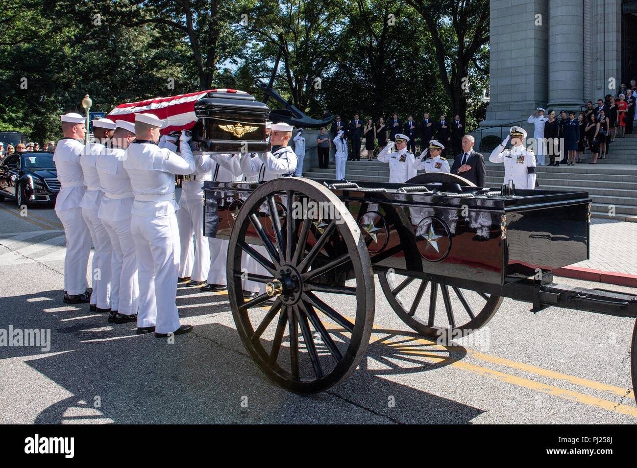 The flag draped casket of Sen. John McCain is lifted by Midshipmen on to a horse-drawn caisson for the procession to the United States Naval Academy Cemetery for his burial service September 2, 2018 in Annapolis, Maryland. John S. McCain, III graduated from the United States Naval Academy in 1958. He was a pilot in the United States Navy, a prisoner of war in Vietnam, a Congressmen and Senator and twice presidential candidate. He received numerous awards, including the Silver Star, Legion of Merit, Purple Heart, and Distinguished Flying Cross. Stock Photo