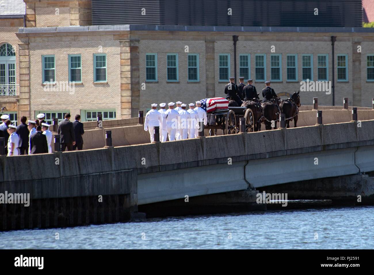 The flag draped casket of Sen. John McCain is carried on a horse-drawn caisson to the United States Naval Academy Cemetery for his burial service September 2, 2018 in Annapolis, Maryland. John S. McCain, III graduated from the United States Naval Academy in 1958. He was a pilot in the United States Navy, a prisoner of war in Vietnam, a Congressmen and Senator and twice presidential candidate. He received numerous awards, including the Silver Star, Legion of Merit, Purple Heart, and Distinguished Flying Cross. Stock Photo