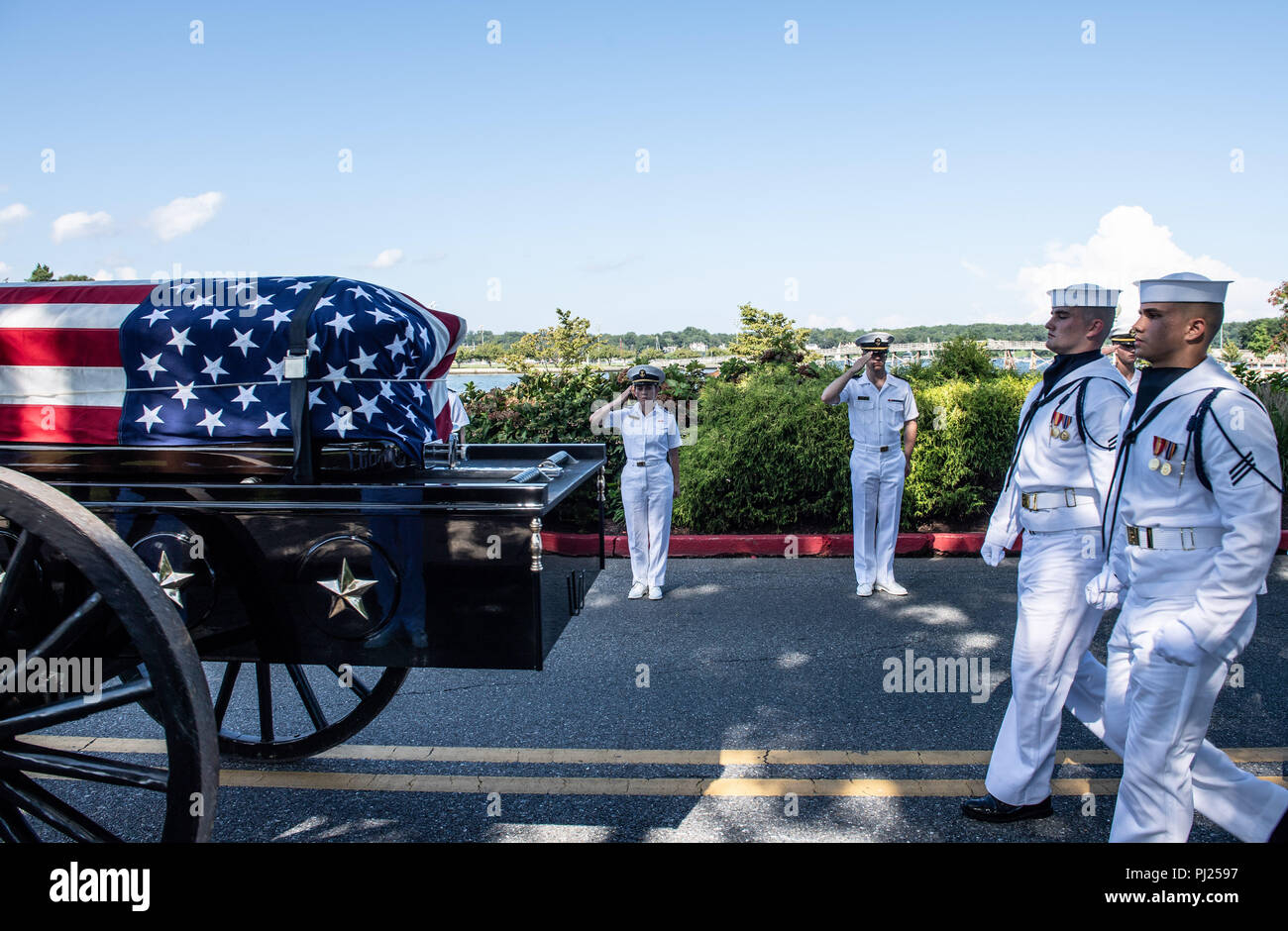 Midshipmen salute as the flag draped casket of Sen. John McCain as a horse-drawn caisson processes to the United States Naval Academy Cemetery for his burial service September 2, 2018 in Annapolis, Maryland. John S. McCain, III graduated from the United States Naval Academy in 1958. He was a pilot in the United States Navy, a prisoner of war in Vietnam, a Congressmen and Senator and twice presidential candidate. He received numerous awards, including the Silver Star, Legion of Merit, Purple Heart, and Distinguished Flying Cross. Stock Photo