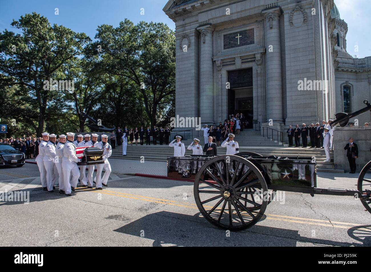 The flag draped casket of Sen. John McCain is lifted by Midshipmen on to a horse-drawn caisson for the procession to the United States Naval Academy Cemetery for his burial service September 2, 2018 in Annapolis, Maryland. John S. McCain, III graduated from the United States Naval Academy in 1958. He was a pilot in the United States Navy, a prisoner of war in Vietnam, a Congressmen and Senator and twice presidential candidate. He received numerous awards, including the Silver Star, Legion of Merit, Purple Heart, and Distinguished Flying Cross. Stock Photo