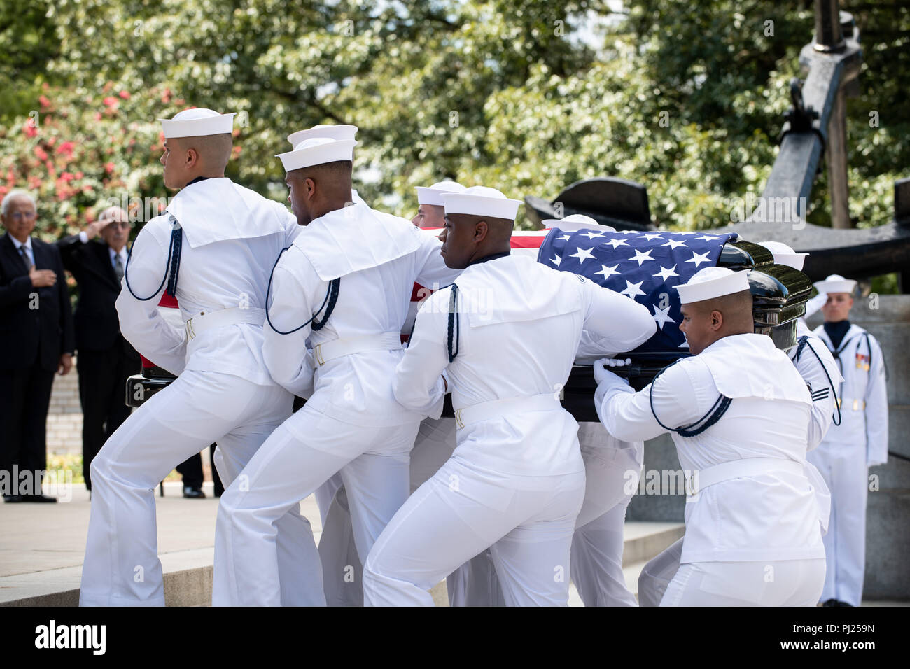 The flag draped casket of Sen. John McCain is carried by Midshipmen from the horse-drawn caisson to the final resting place at the United States Naval Academy Cemetery September 2, 2018 in Annapolis, Maryland. John S. McCain, III graduated from the United States Naval Academy in 1958. He was a pilot in the United States Navy, a prisoner of war in Vietnam, a Congressmen and Senator and twice presidential candidate. He received numerous awards, including the Silver Star, Legion of Merit, Purple Heart, and Distinguished Flying Cross. Stock Photo