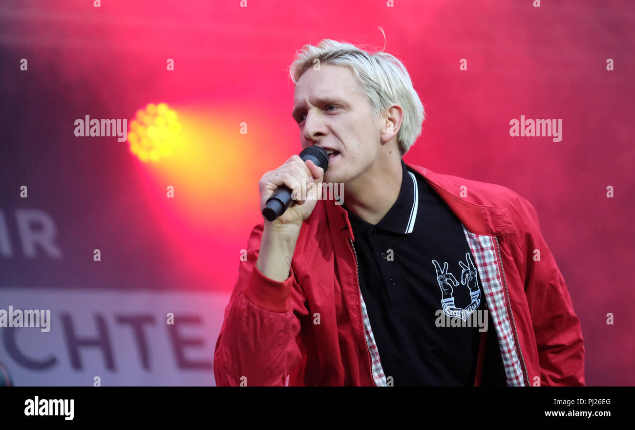 03.09.2018, Saxony, Chemnitz: Singer Felix Brummer of the rock band  Kraftklub from Chemnitz is on stage at a concert under the motto 