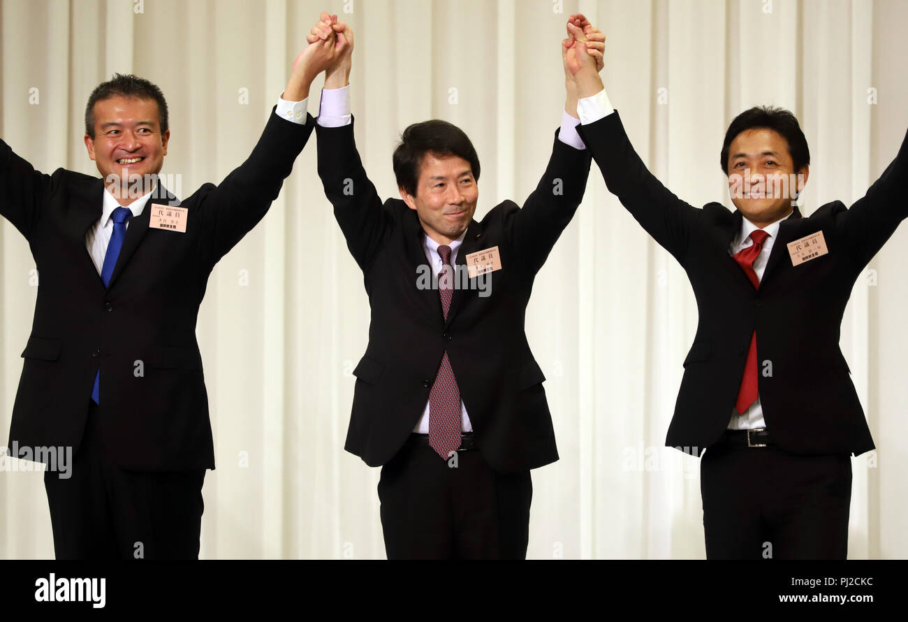 Tokyo, Japan. 4th Sep, 2018. Japan's second largest opposition Democratic Party for the People president Kohei Otsuka (C ) raises hands of the new president Yuichiro Tamaki (R) and and another candidate Keisuke Tsumura (L) after Tamaki was elected at the party convention in Tokyo on Tuesday, September 4, 2018. The Democratic Party for the People was formed in May as merger of Democratic Party of Japan and Party of Hope. Credit: Yoshio Tsunoda/AFLO/Alamy Live News Stock Photo