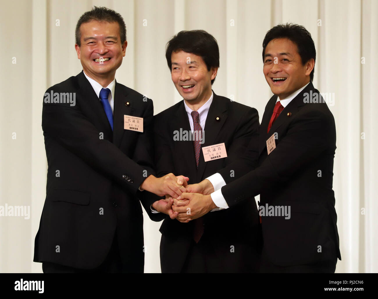 Tokyo, Japan. 4th Sep, 2018. Japan's second largest opposition Democratic Party for the People president Kohei Otsuka (C) shakes hands with the new president Yuichiro Tamaki (R) and and another candidate Keisuke Tsumura (L) after Tamaki was elected at the party convention in Tokyo on Tuesday, September 4, 2018. The Democratic Party for the People was formed in May as merger of Democratic Party of Japan and Party of Hope. Credit: Yoshio Tsunoda/AFLO/Alamy Live News Stock Photo