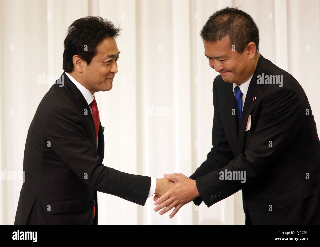 Tokyo, Japan. 4th Sep, 2018. Japan's second largest opposition Democratic Party for the People new president Yuichiro Tamaki (L) shakes hands with another candidate Keisuke Tsumura (R) as he was elected for the party leader at the party convention in Tokyo on Tuesday, September 4, 2018. The Democratic Party for the People was formed in May as merger of Democratic Party of Japan and Party of Hope. Credit: Yoshio Tsunoda/AFLO/Alamy Live News Stock Photo