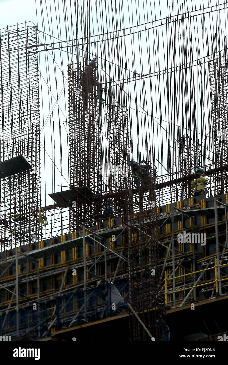 Quezon City, Philippines. 4th Sep, 2018. People work at a construction