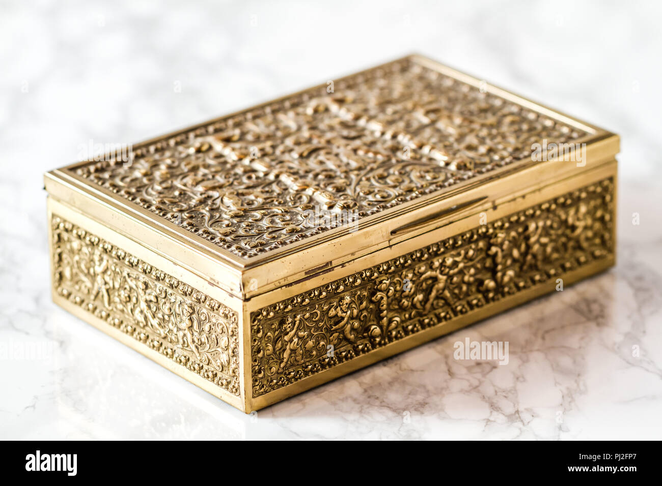Vintage brass metal decorative box on marble background Stock Photo Alamy