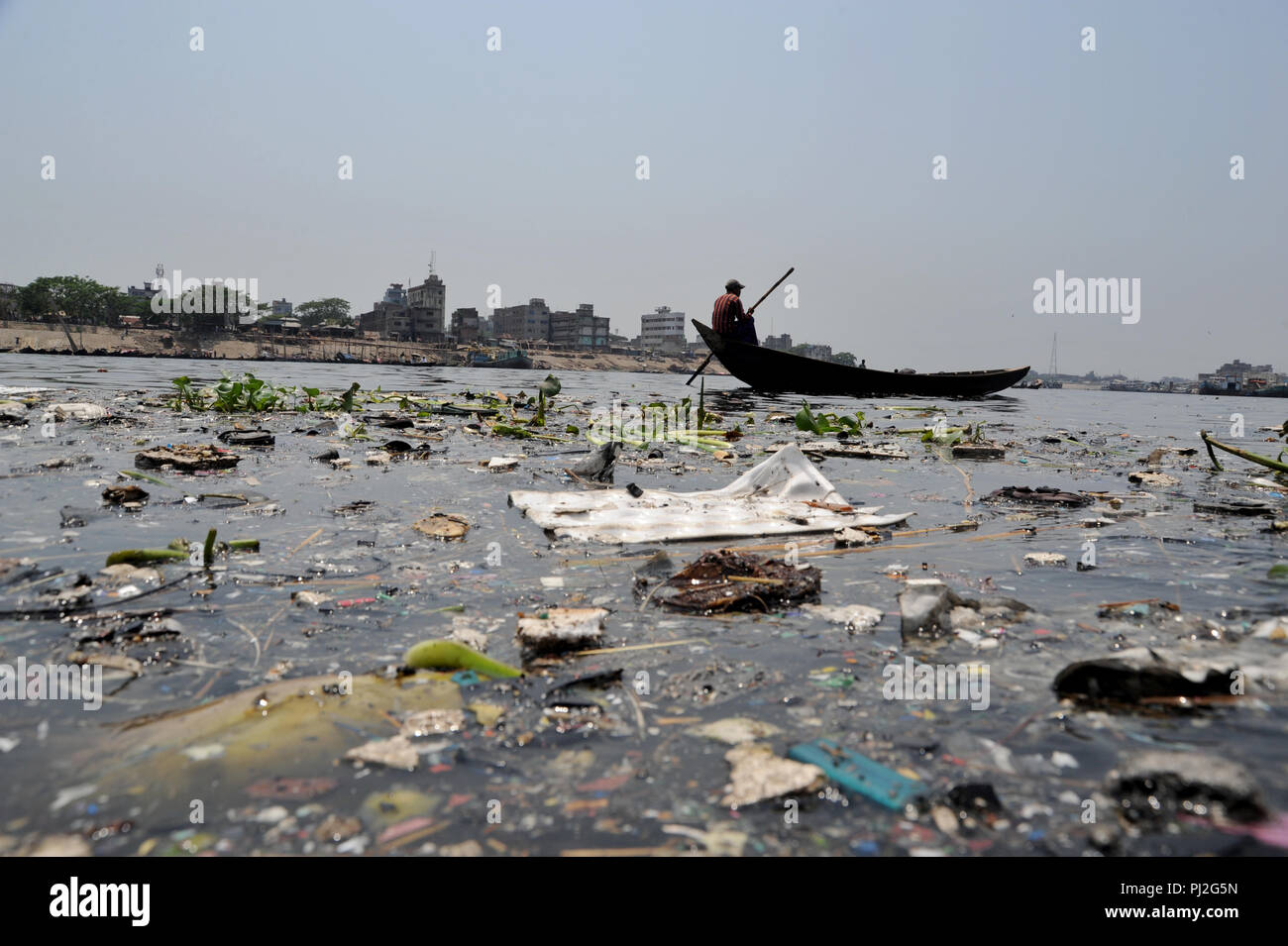 Dhaka, Bangladesh - April 17, 2011: A boat moves over the river buriganga at Dhaka, Bangladesh. Like the other rivers, Dhaka became extremely polluted Stock Photo