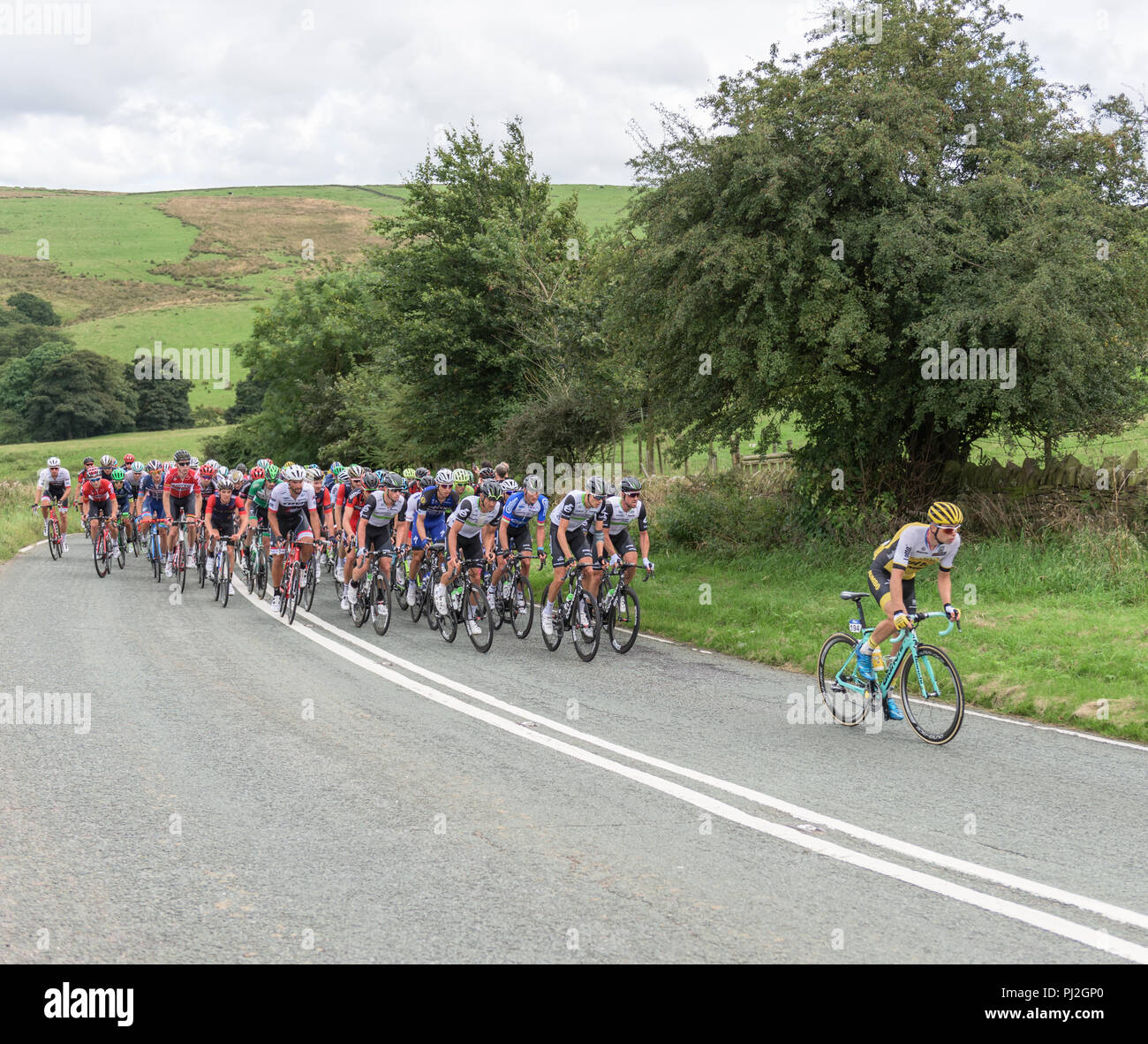 2016 Tour of Britain cyclists riding towards Macclesfield, Cheshire, with the peloton chasing the leader Stock Photo