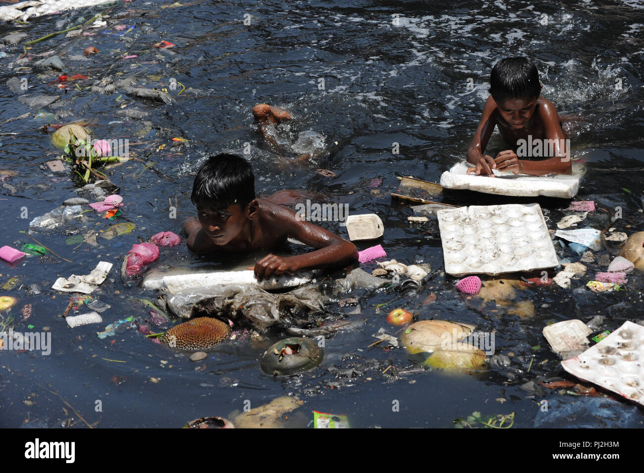 Dhaka, Bangladesh April 22, 2012 Children Swim in Polluted Buriganga