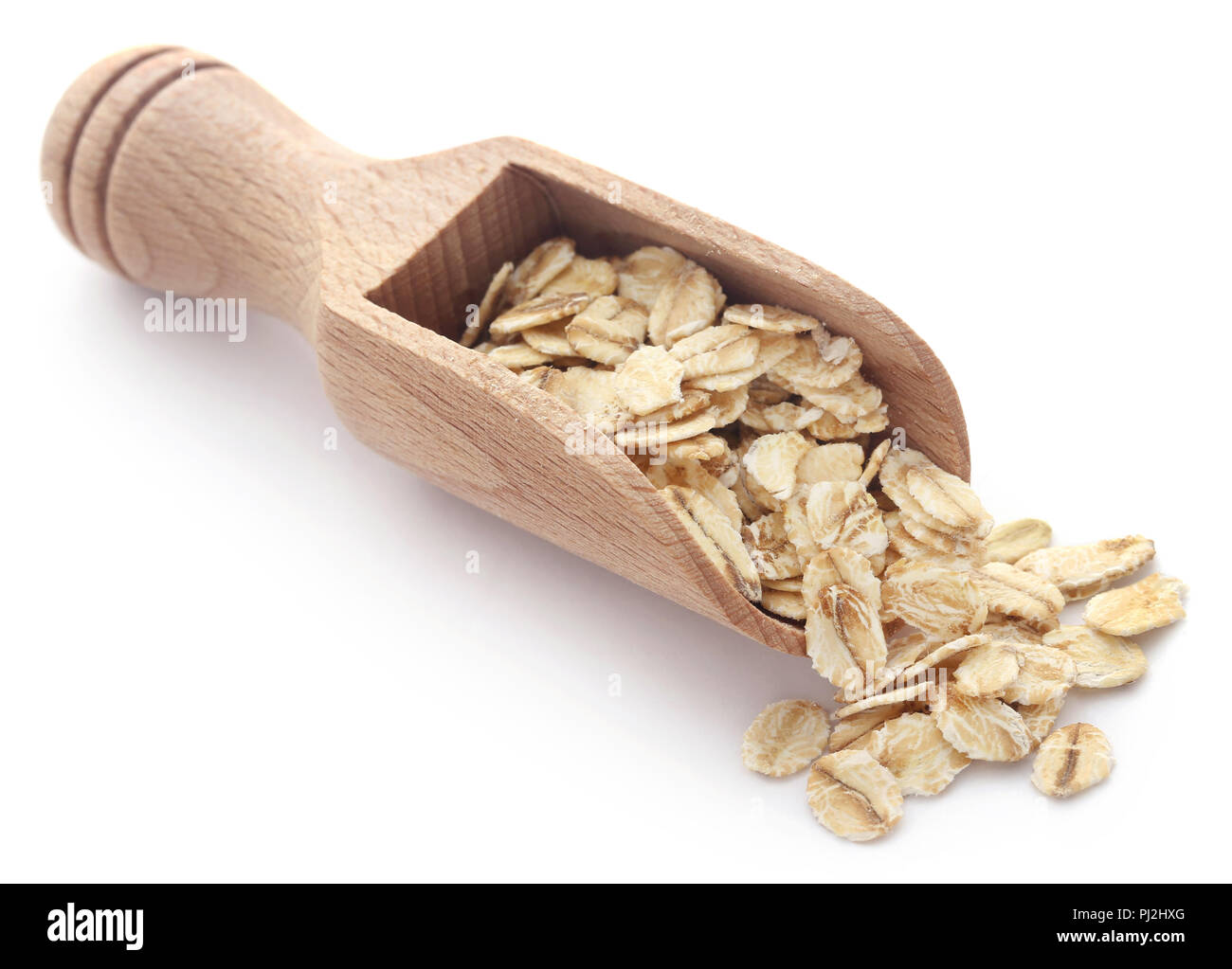 Whole oats in scoop isolated over white background Stock Photo