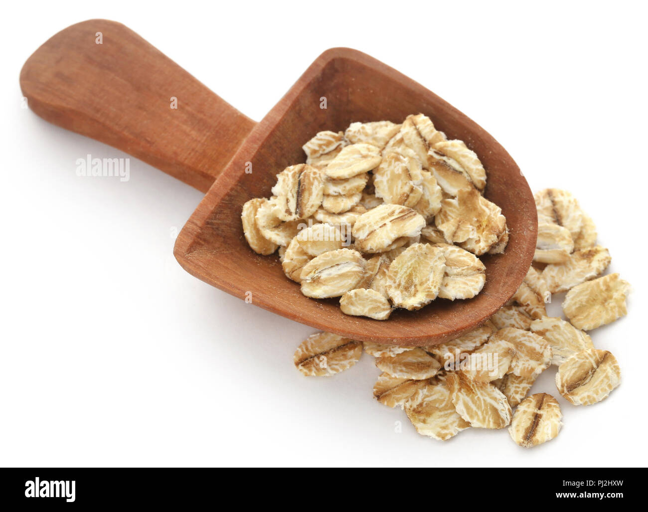 Whole oats in scoop isolated over white background Stock Photo