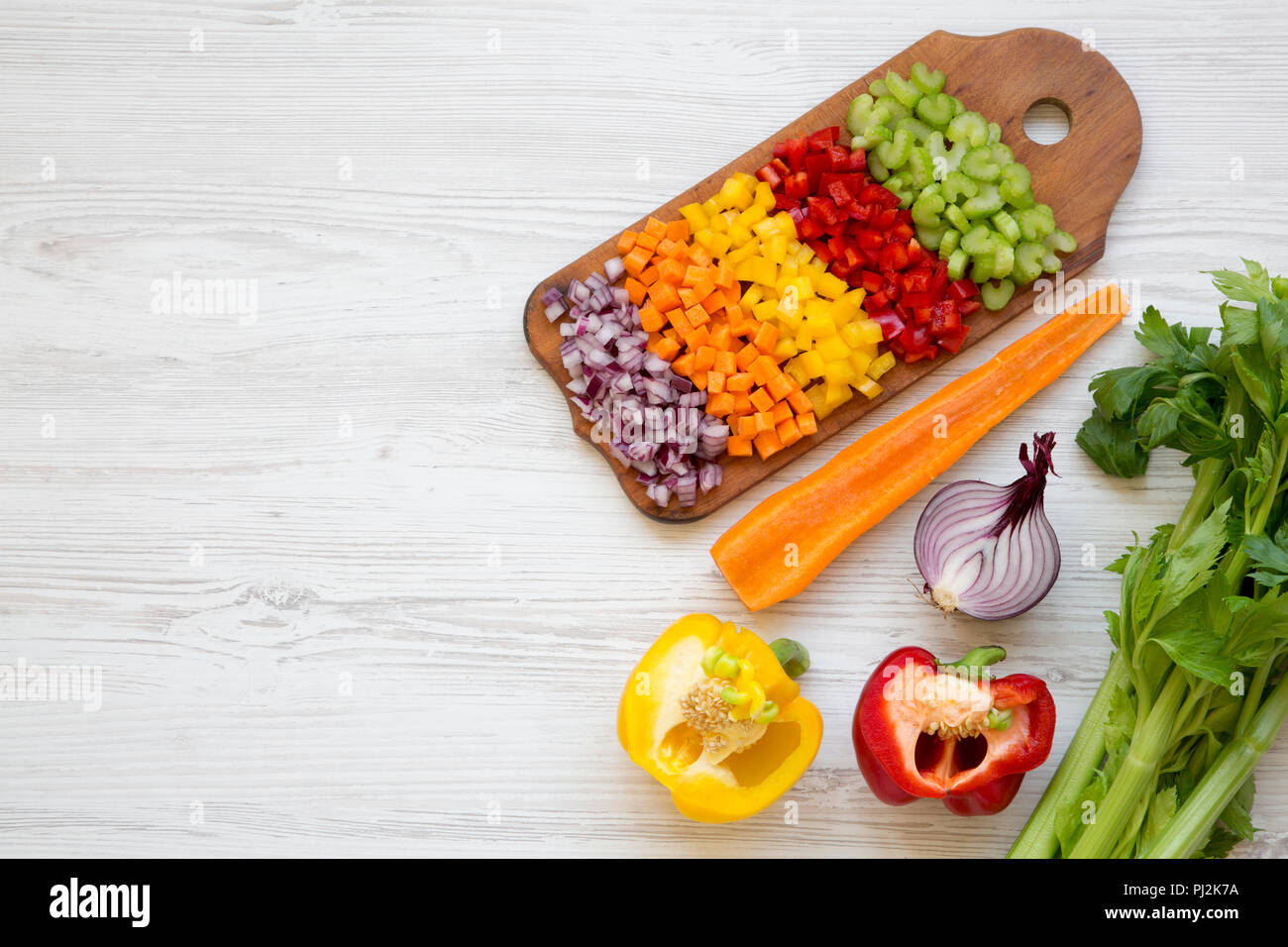 Chopped fresh fruits arranged on cutting board on white wooden surface, top  view. Ingredients for fruit salad. From above, flat lay, overhead Stock  Photo - Alamy