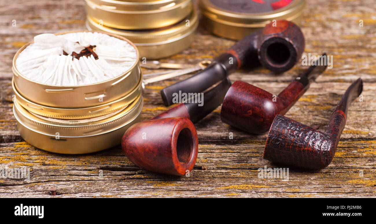 Vintage smoking pipes. Good expensive tobacco. Background of old boards