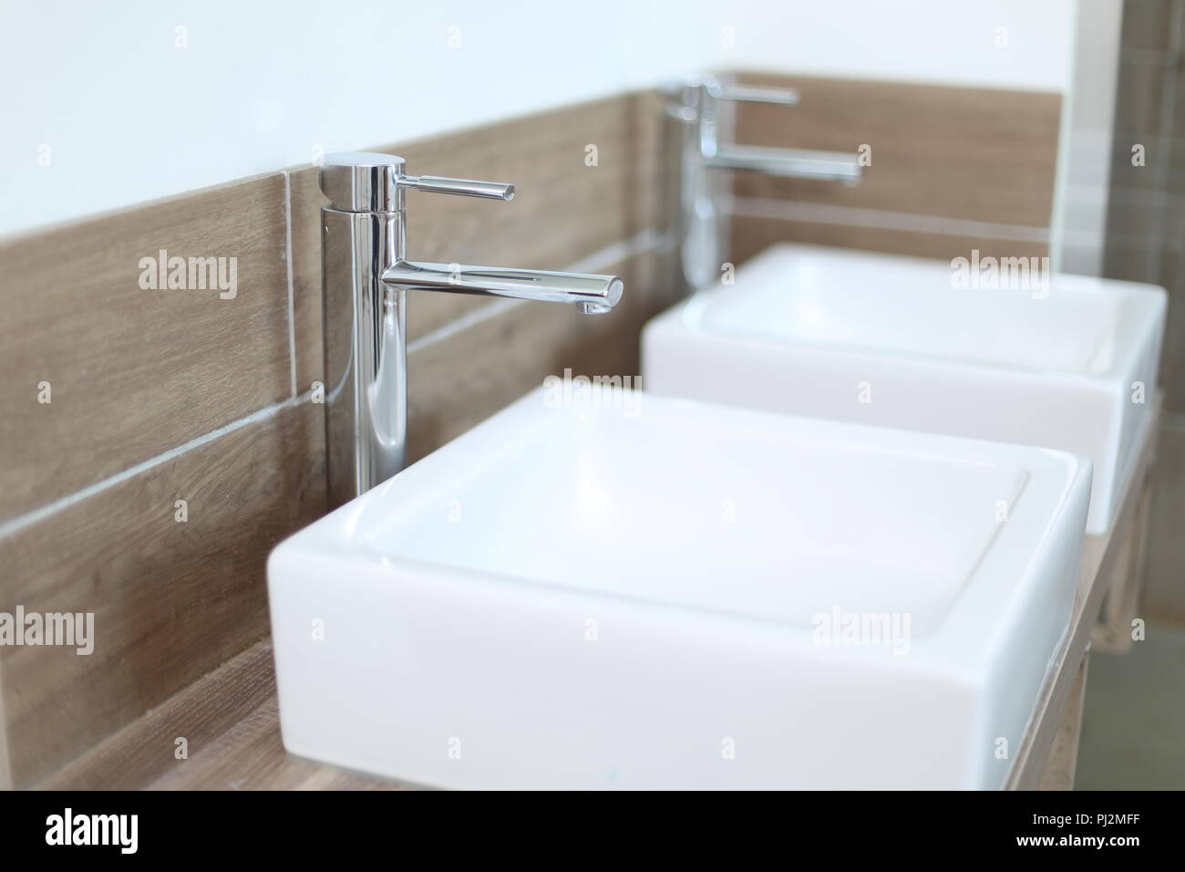 Two Countertop Washbasins In A Modern Bathroom With Depth Of Field