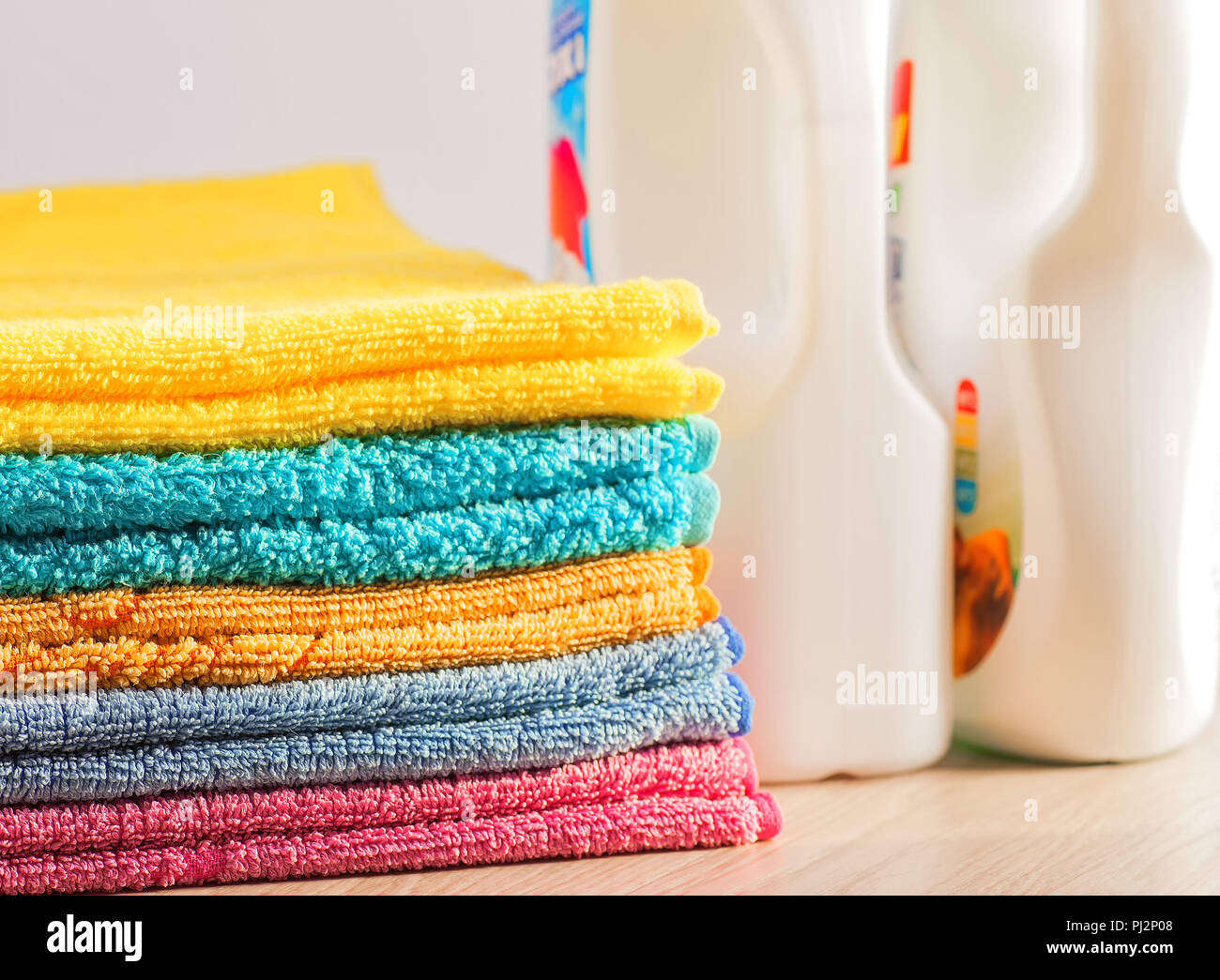 Clean, colorful, folded clothes. Means for washing clothes Stock Photo