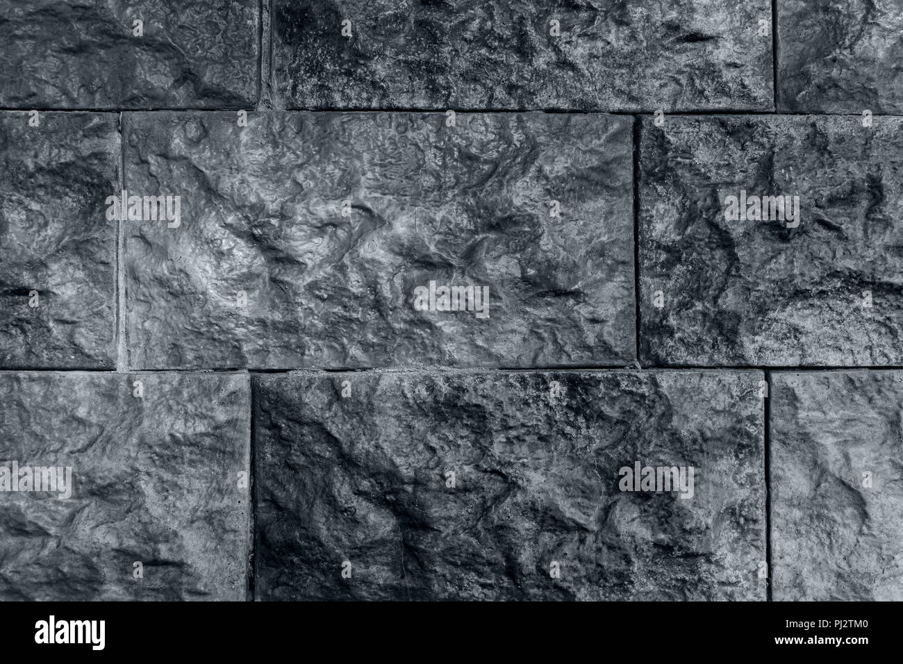 Dark grey background, wall from relief brick, unusual texture Stock Photo