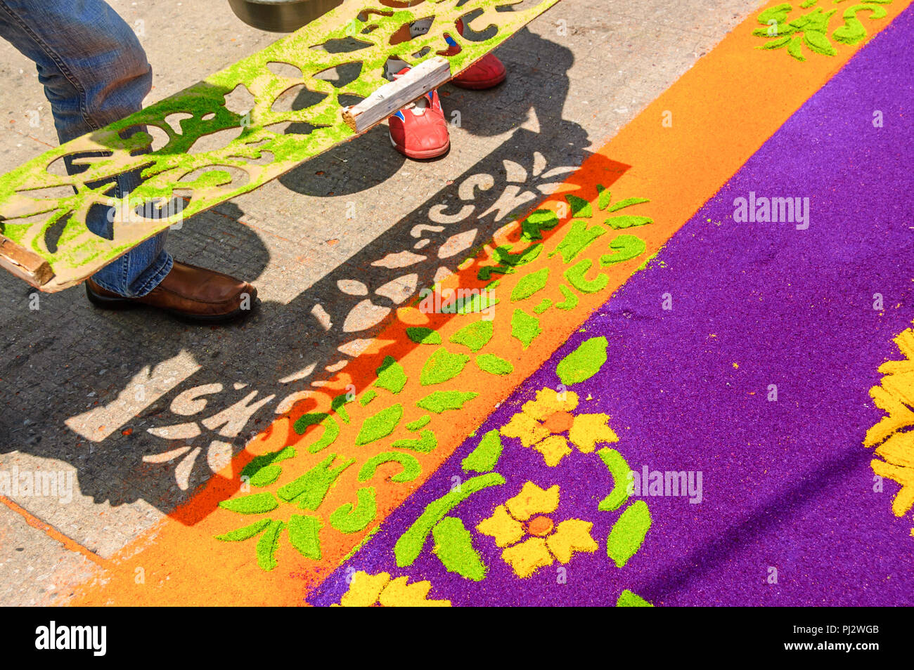 Antigua, Guatemala -  April 2, 2015: Making Holy Week procession carpet in colonial town with most famous Holy Week celebrations in Latin America. Stock Photo
