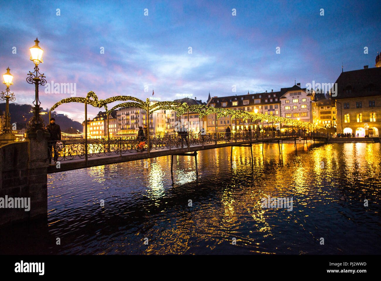 Arched iron footbridge over the River Reuss in Lucerne, Switzerland. Stock Photo