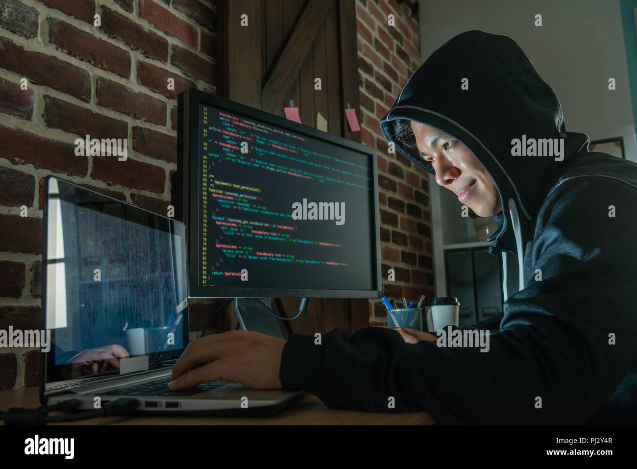 man using electronic devices to blackmail people and getting illigal money for makiing a living. Stock Photo