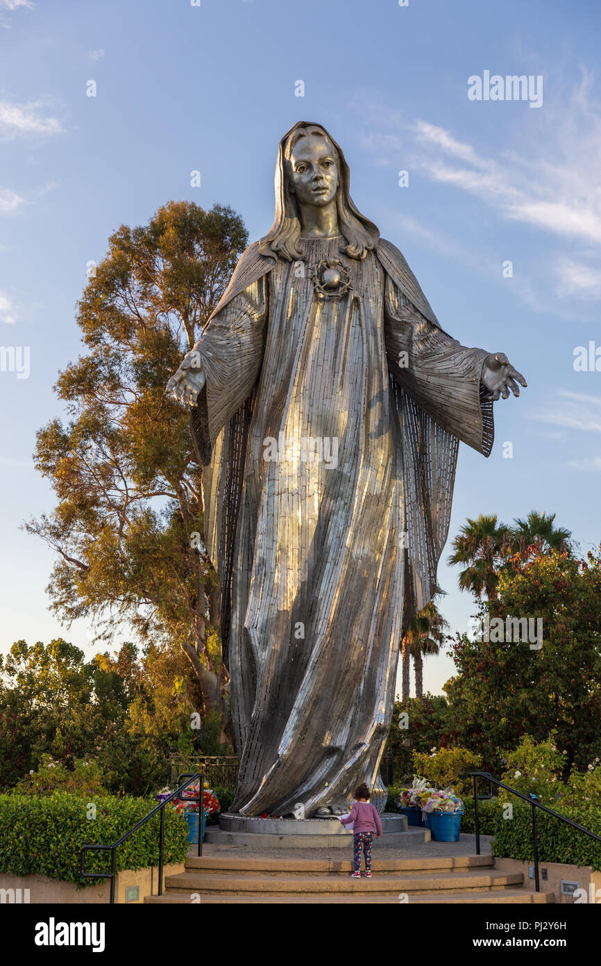 Little girl in front of Our Lady of Peace, Virgin Mary statue (by Charles C. Parks, 1982), Santa Clara, California Stock Photo