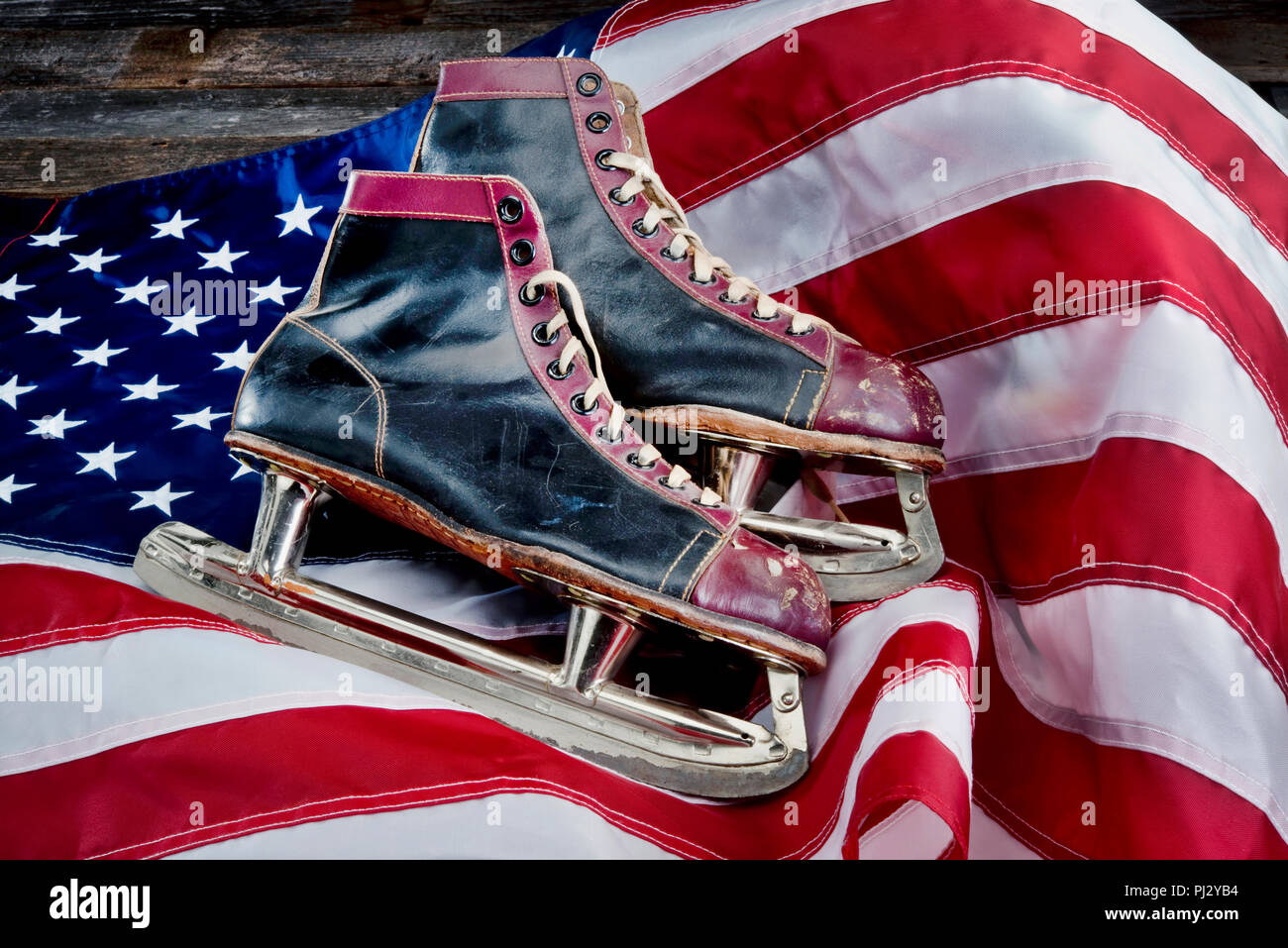Antique ice skates on American flag. Stock Photo