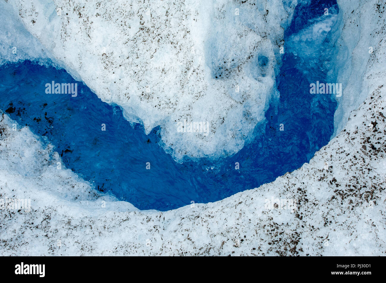 Glacier helicopter tour - Juneau Alaska - cruise ship excursion over the Juneau icefield landing on Gilkey Glacier - stunning blue glacial meltwater Stock Photo