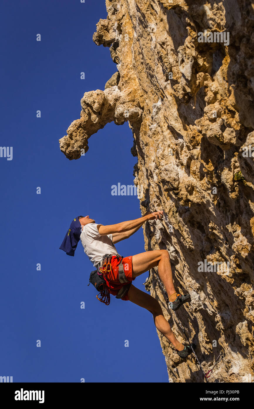Rock climber on lime stone in Kalymnos, Greece. Stock Photo