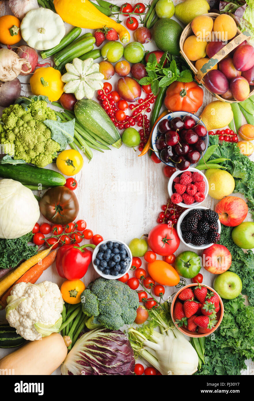 Healthy summer fruits vegetables berries arranged in a circle frame