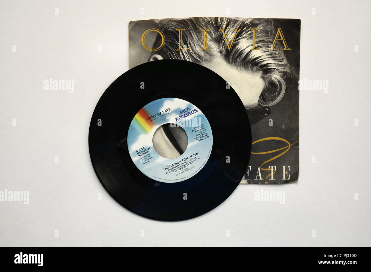 Sleeve and 45 RPM vinyl record of Olivia Newton-John's song "Twist of Fate" released in 1983 by MCA Records. Stock Photo