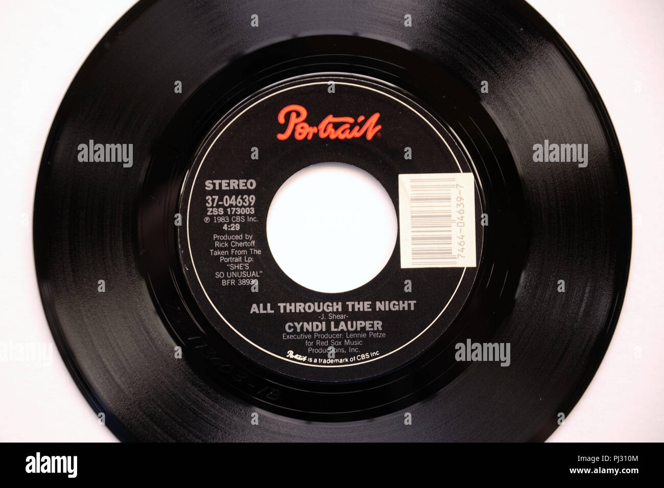 Close-up of the 45 RPM vinyl record of Cyndi Lauper's song 'All Through The Night' released in 1983 by Portrait Records. Stock Photo
