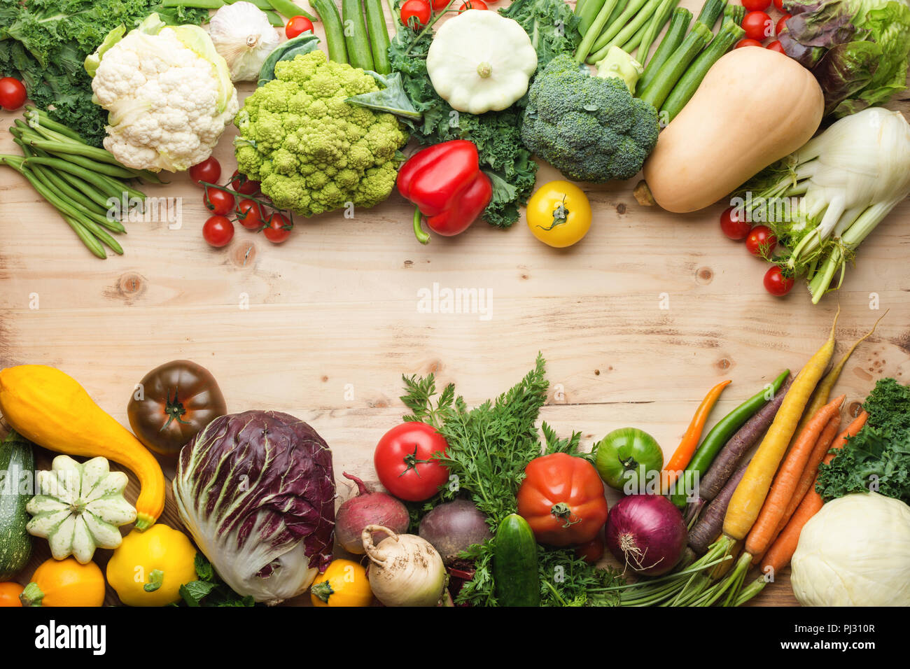 https://c8.alamy.com/comp/PJ310R/fresh-farm-produce-organic-vegetables-and-herbs-on-pine-wooden-table-healthy-background-copy-space-for-text-in-the-middle-top-view-selective-focus-PJ310R.jpg