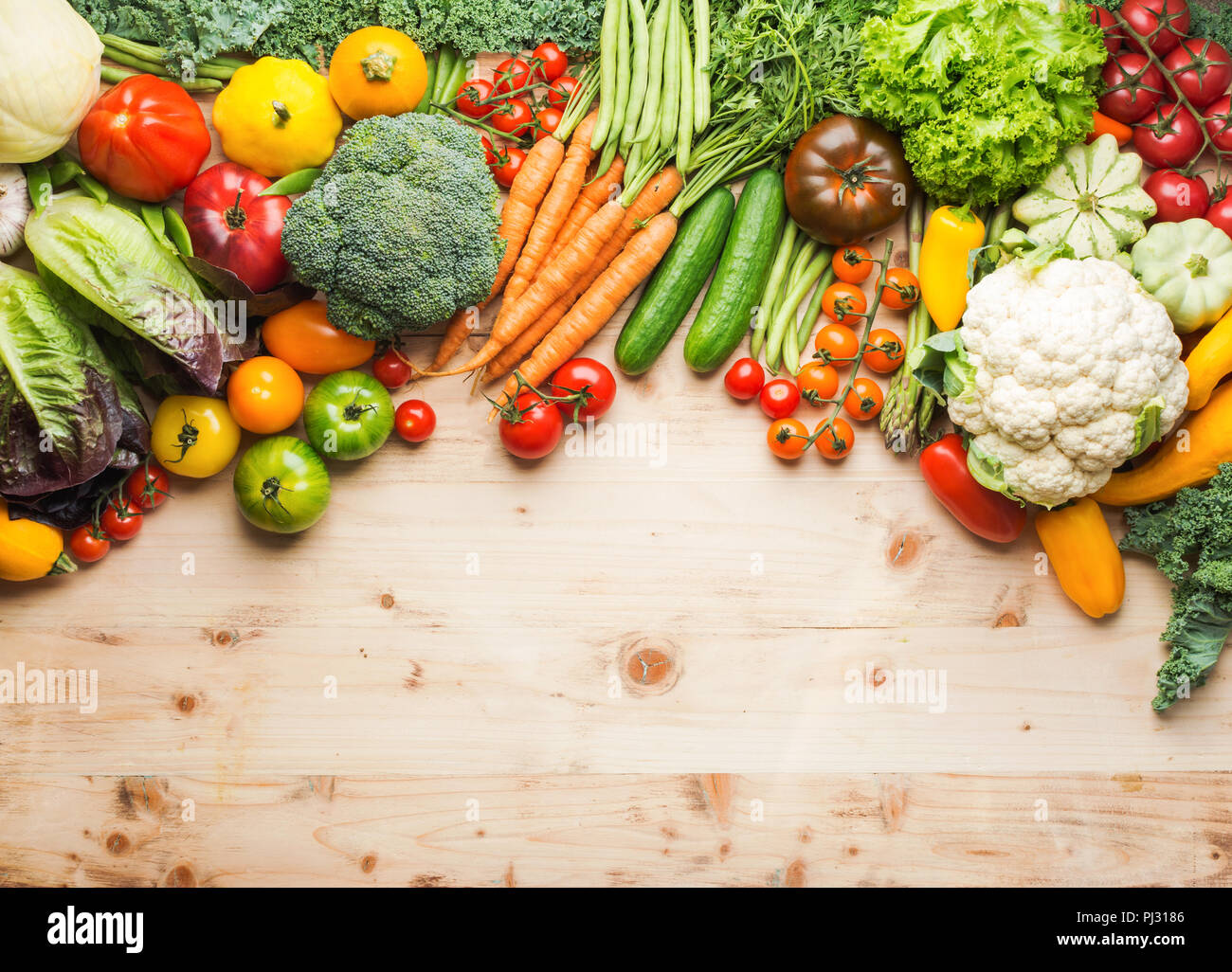 Fresh farm produce, organic vegetables on wooden pine table, healthy background, copy space for text on the bottom, top view, selective focus Stock Photo