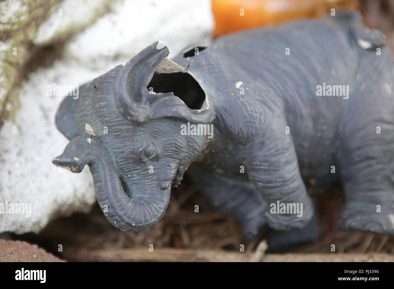 broken elephant statue in a garbage can Stock Photo Alamy