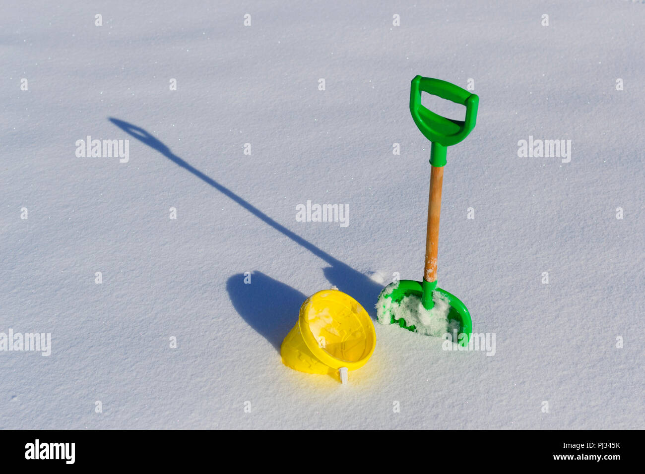 Childrens shovel and bucket in deep fresh clean snow photo Stock Photo ...